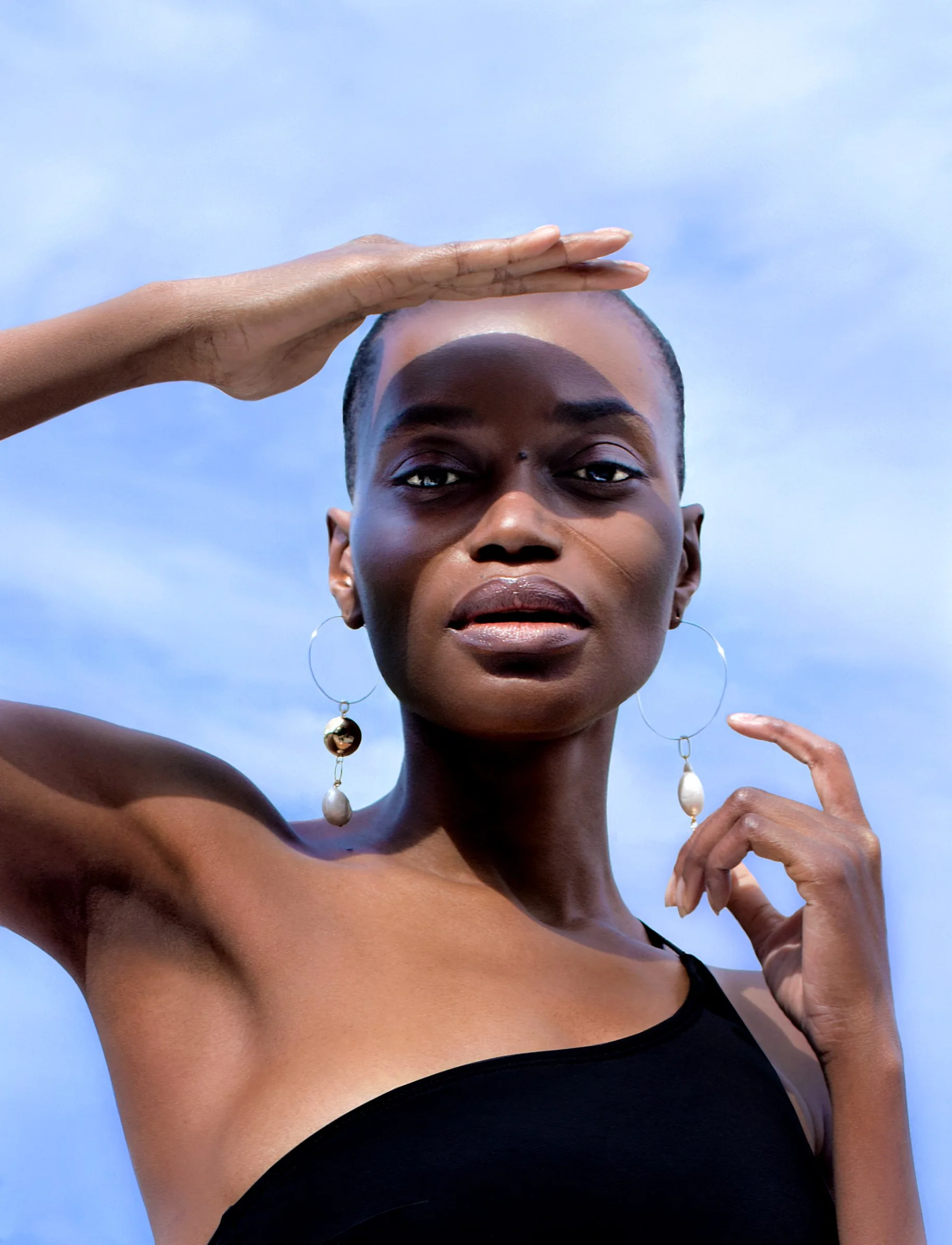 Ovo shielding her eyes against a periwinkle sky, from Afterglow